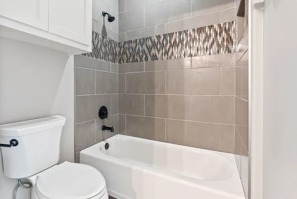 a bathroom with a toilet and bathtub