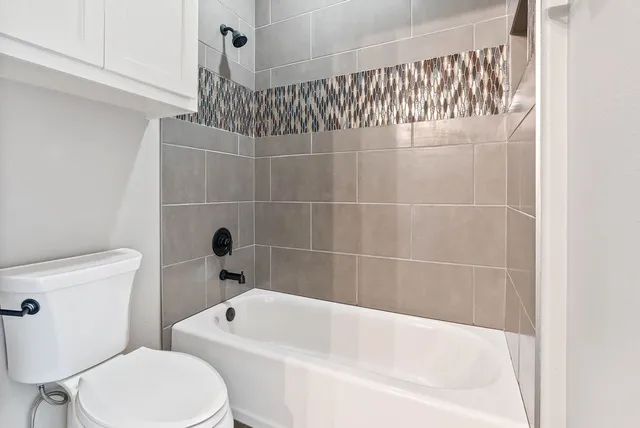 a bathroom with a toilet and bathtub