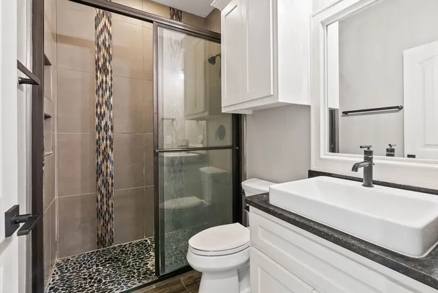 a bathroom with a sink toilet and shower