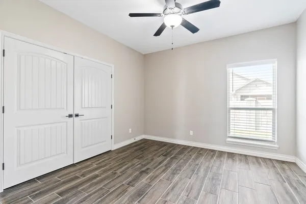 wooden floor in an empty room with a window