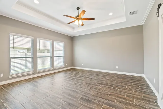 wooden floor in an empty room with a window