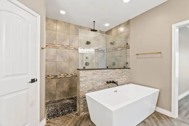 a bathroom with a sink a shower and a mirror