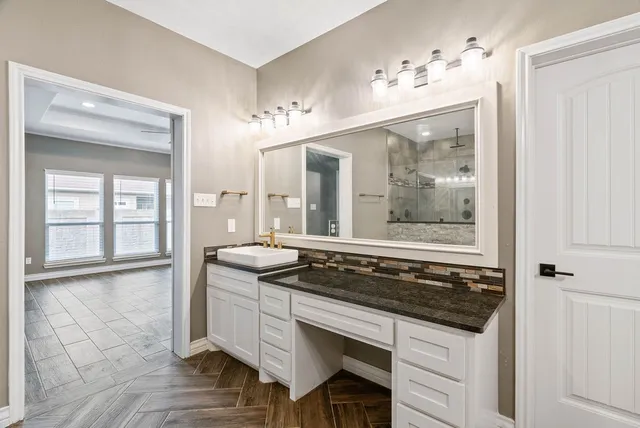 a bathroom with a sink and a mirror