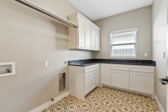 a kitchen with a sink cabinets and wooden floor