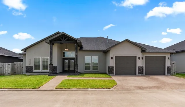 a front view of a house with a yard and garage