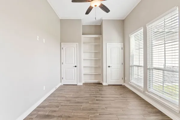 wooden floor in an empty room with a window