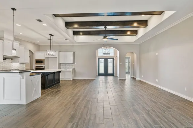 a view of entryway and kitchen with wooden floor
