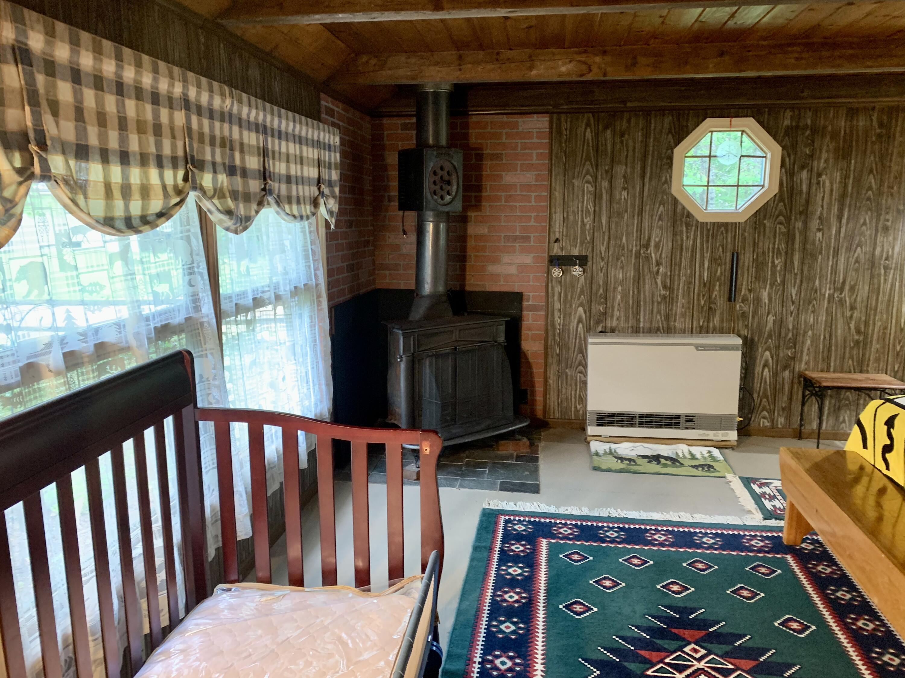 1004 Sherbino Road Carrabassett Valley, ME 04947 - Photo 12 of 18 Main Bedroom with Wood Stove