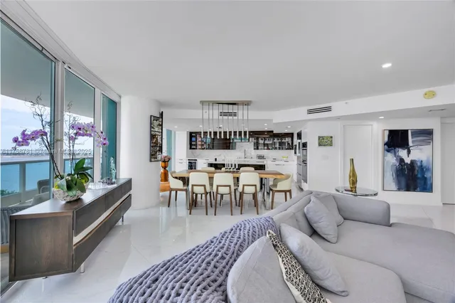 a living room with furniture and a dining room
