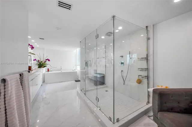 a white bath tub sitting next to a shower