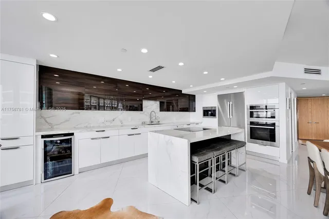 a kitchen with stainless steel appliances kitchen island granite countertop a sink and cabinets