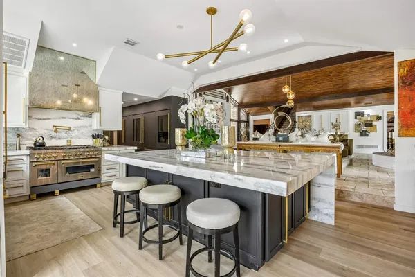a kitchen with a stove a sink and a refrigerator