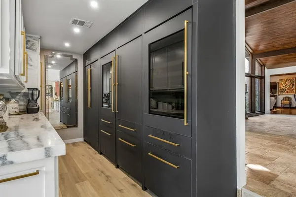 a living room with furniture a flat screen tv and a large window