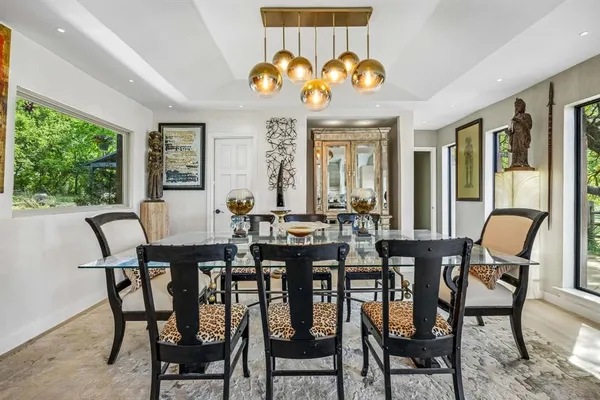 a living room with furniture a fireplace and a chandelier