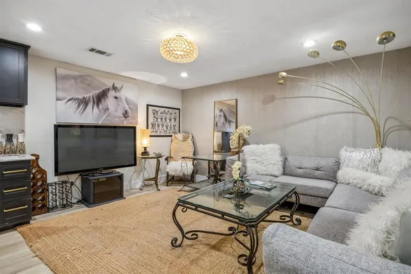 a view of a patio with a table and chairs and potted plants
