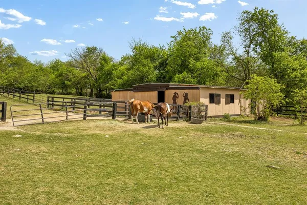 a view of a swimming pool with a bench and trees