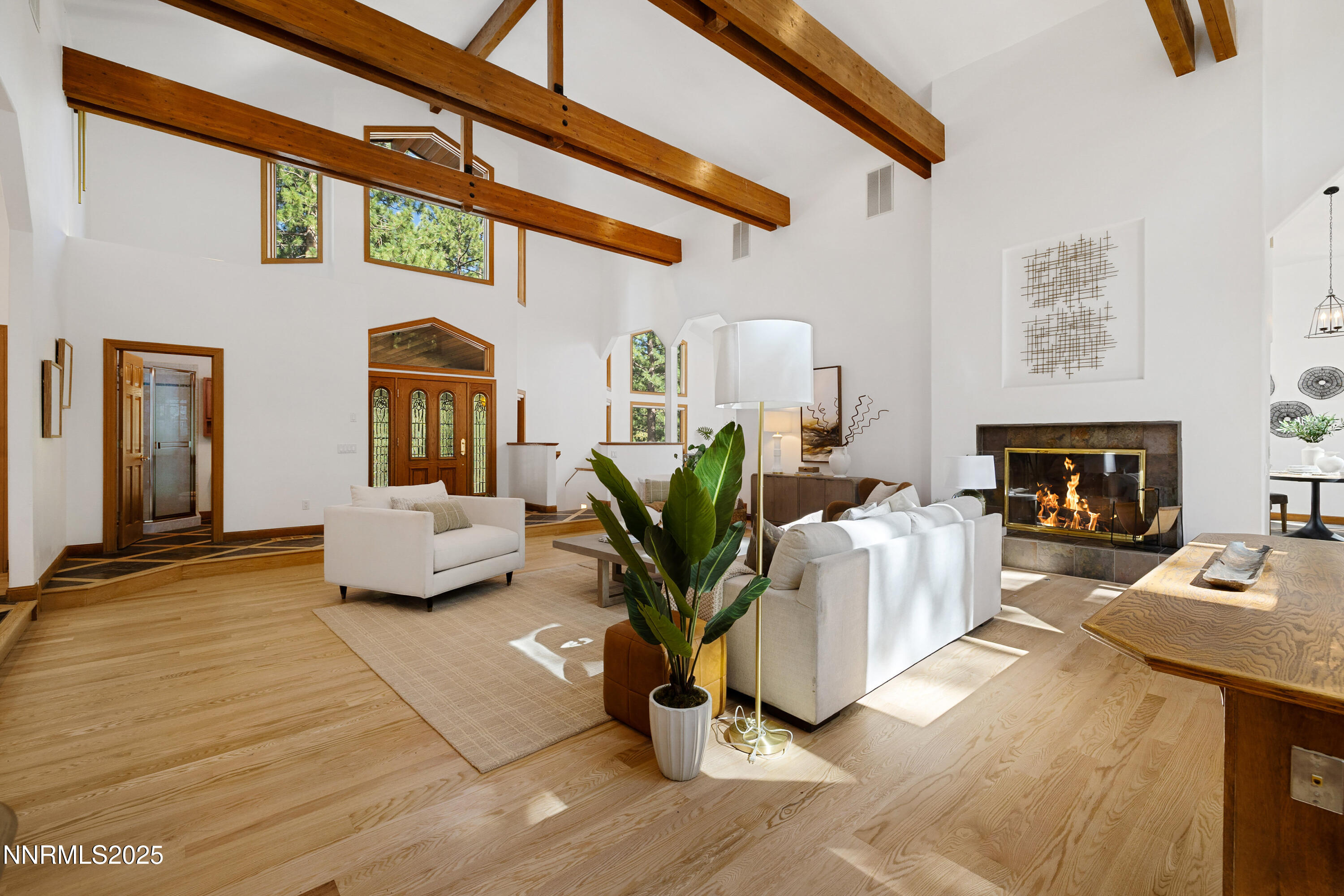1745 Green Ash Drive Reno, NV 89511 - Photo 12 of 64 a living room with furniture a fireplace and a flat screen tv