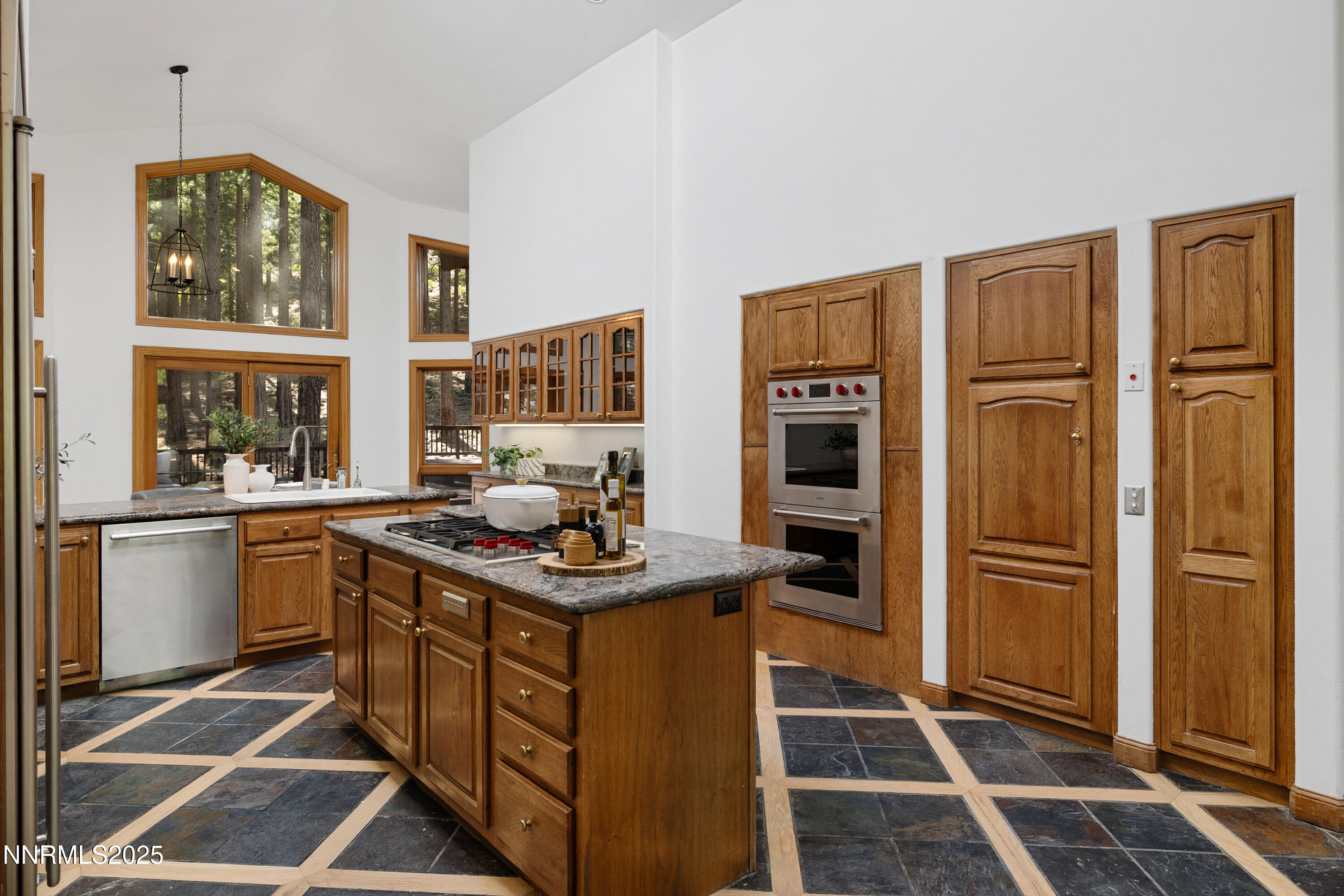 1745 Green Ash Drive Reno, NV 89511 - Photo 15 of 64 a kitchen with stainless steel appliances granite countertop a stove a sink and a refrigerator