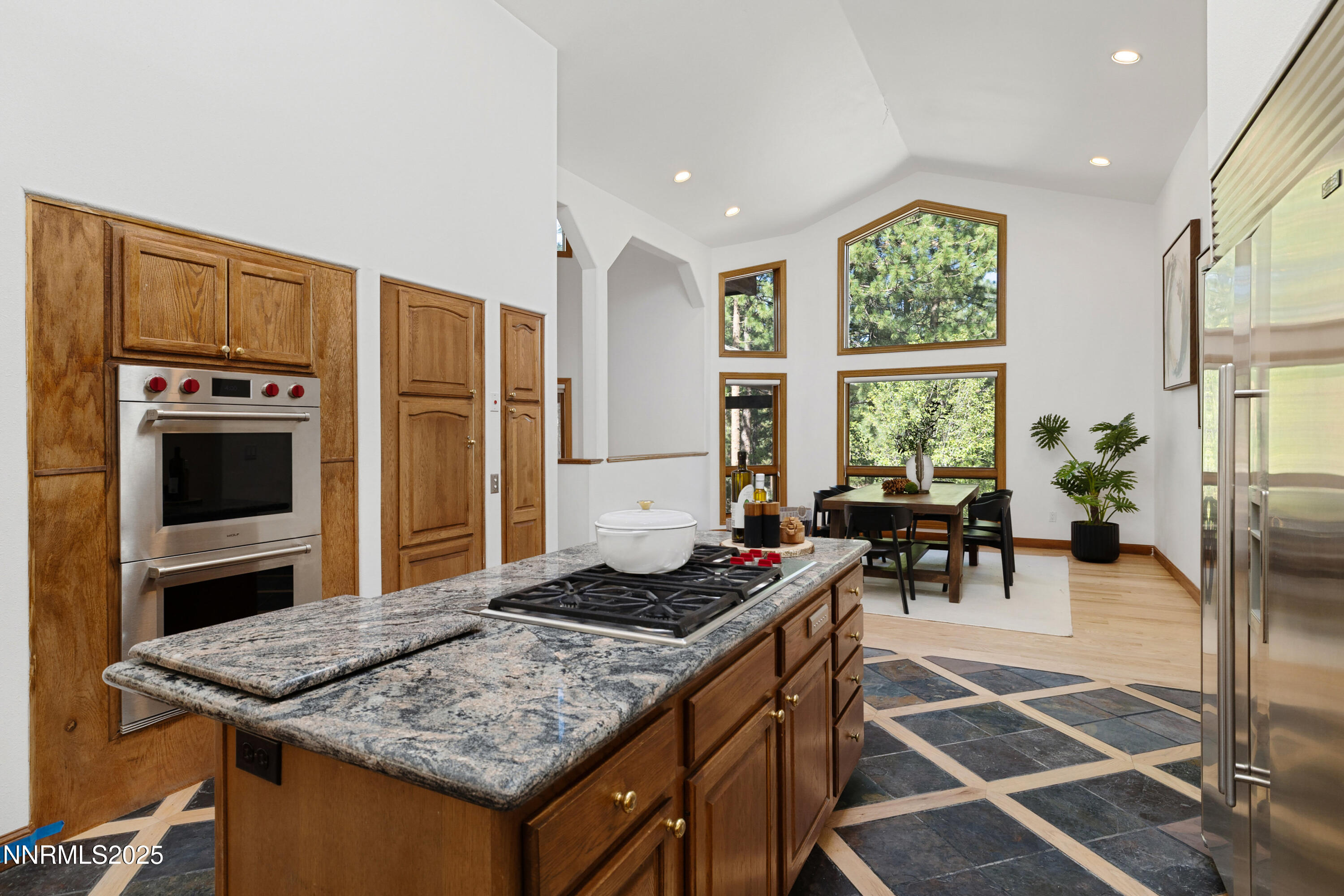 1745 Green Ash Drive Reno, NV 89511 - Photo 16 of 64 a kitchen with stainless steel appliances granite countertop a stove a refrigerator and a dining table