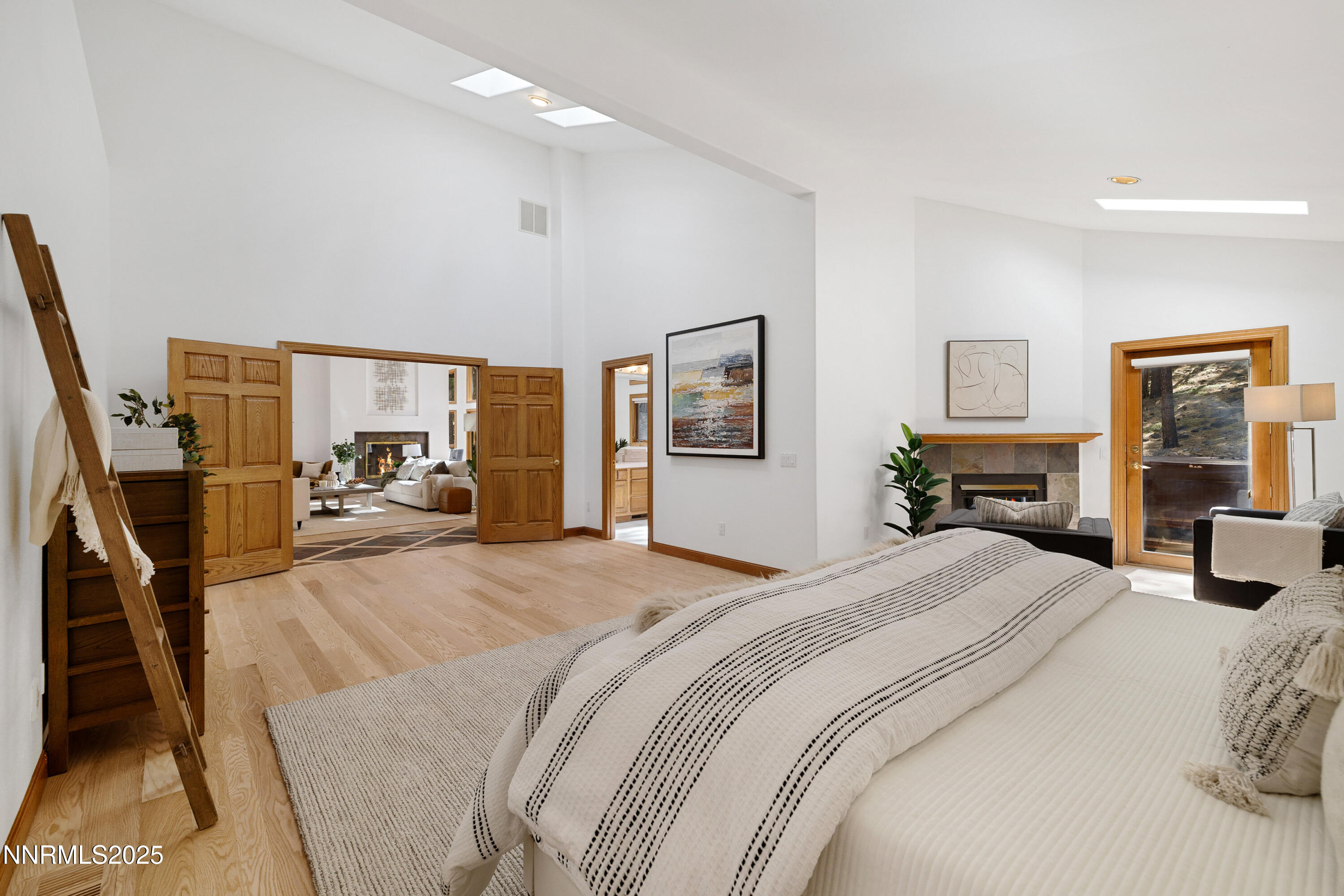 1745 Green Ash Drive Reno, NV 89511 - Photo 26 of 64 a bedroom with a large bed and a flat tv screen