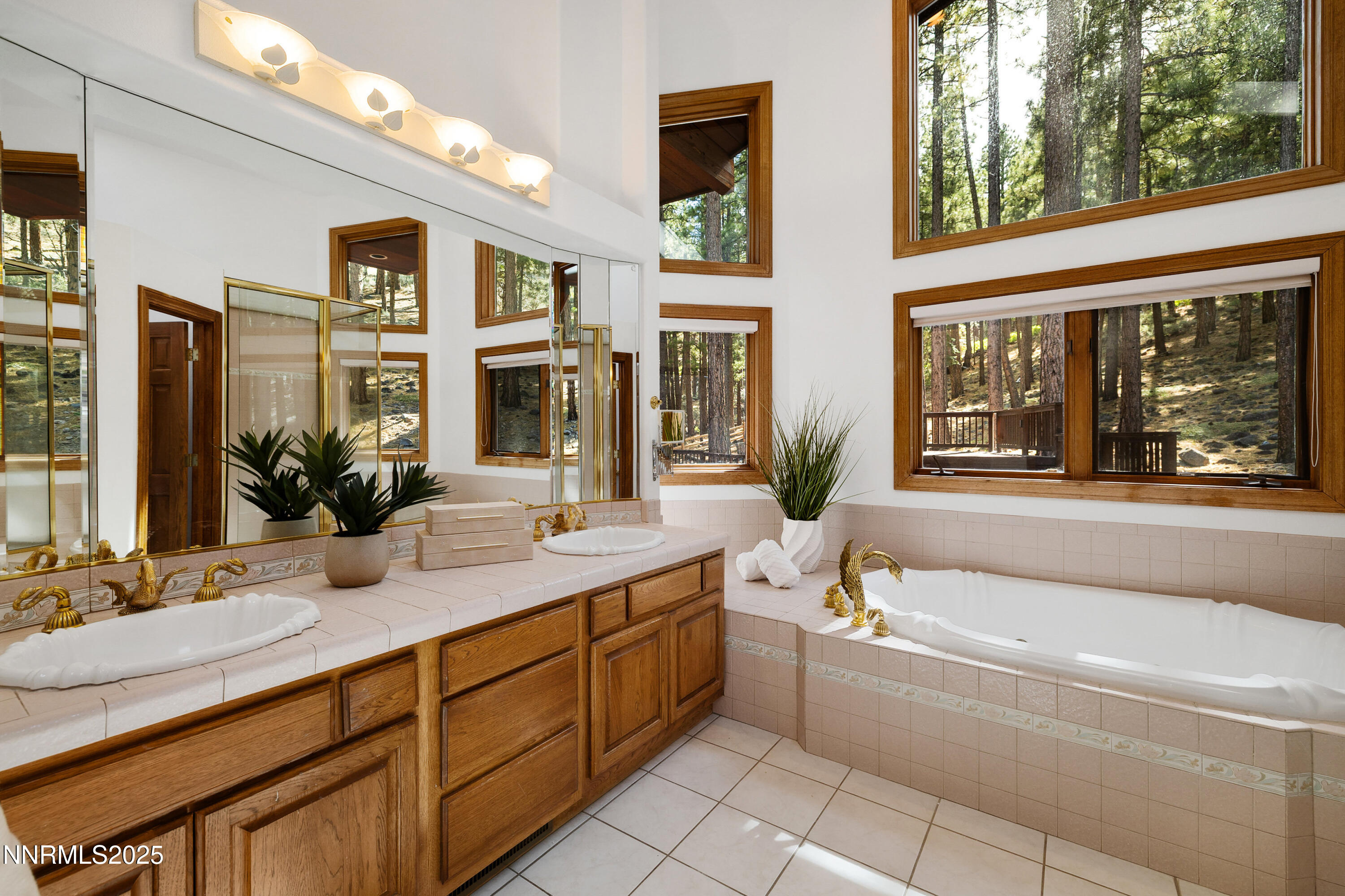 1745 Green Ash Drive Reno, NV 89511 - Photo 27 of 64 a bathroom with a granite countertop tub sink and mirror