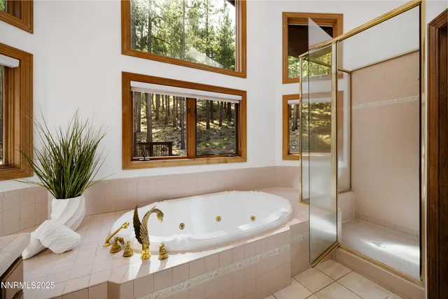a bathroom with a double vanity sink and large mirror