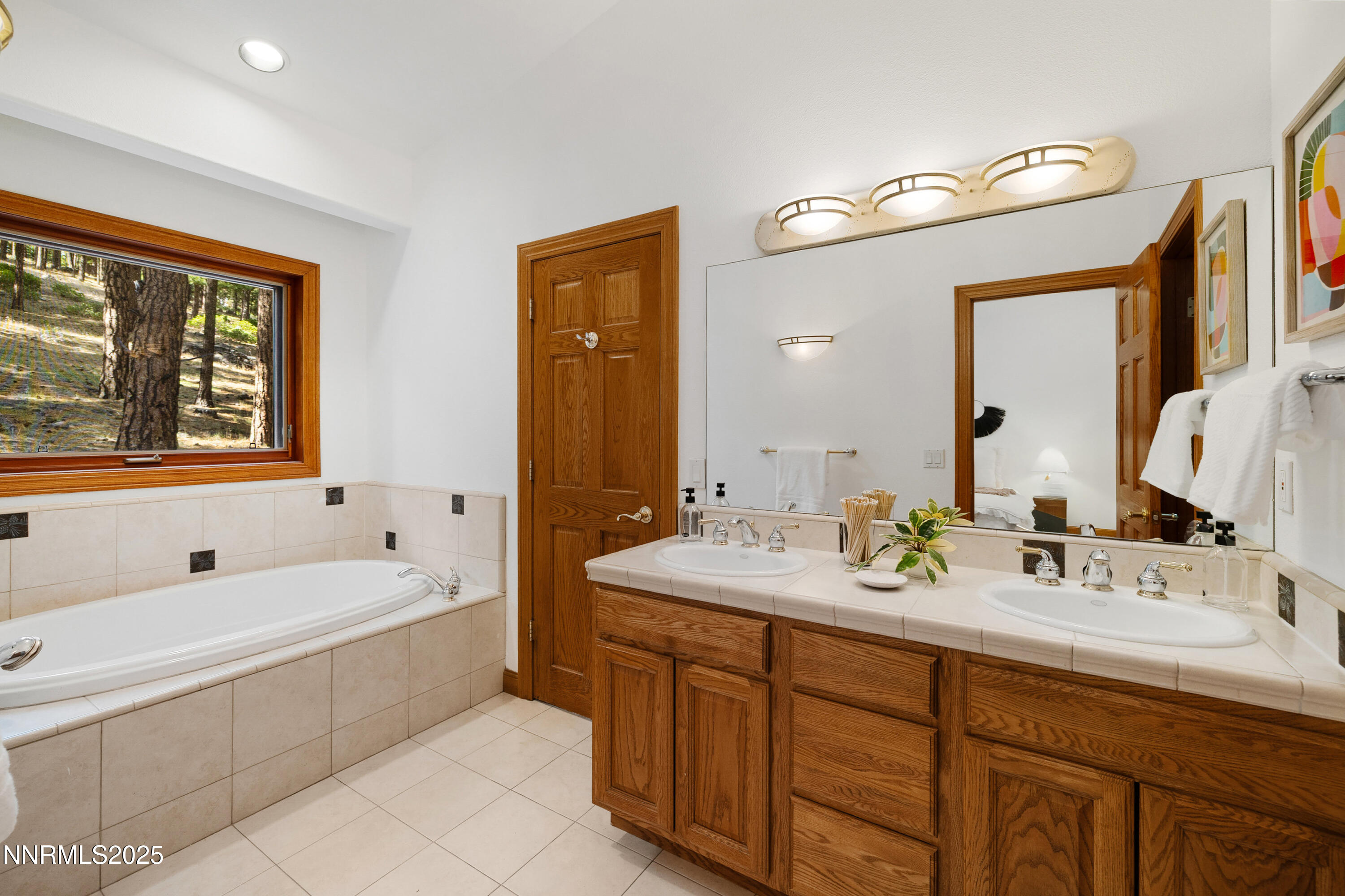 1745 Green Ash Drive Reno, NV 89511 - Photo 45 of 64 a spacious bathroom with a double vanity sink tub and mirror