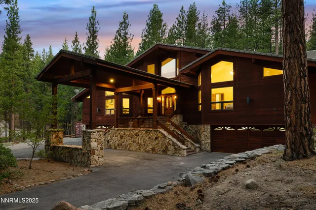 a view of a house with a large tree
