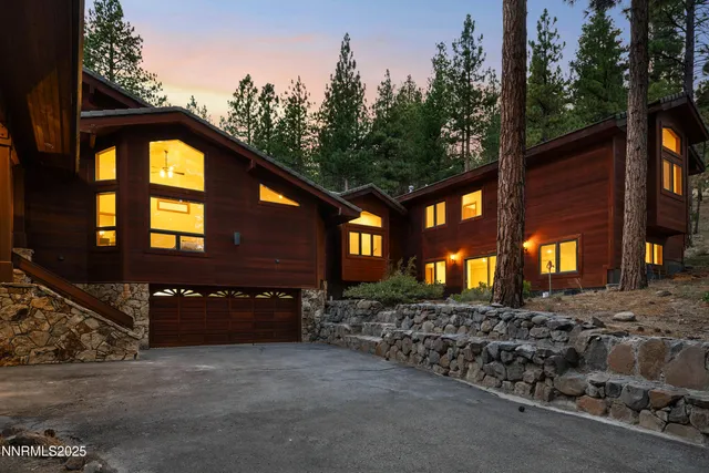 a living room with furniture and large windows