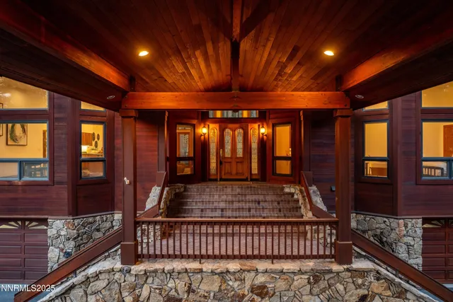 a living room with furniture large window and wooden floor
