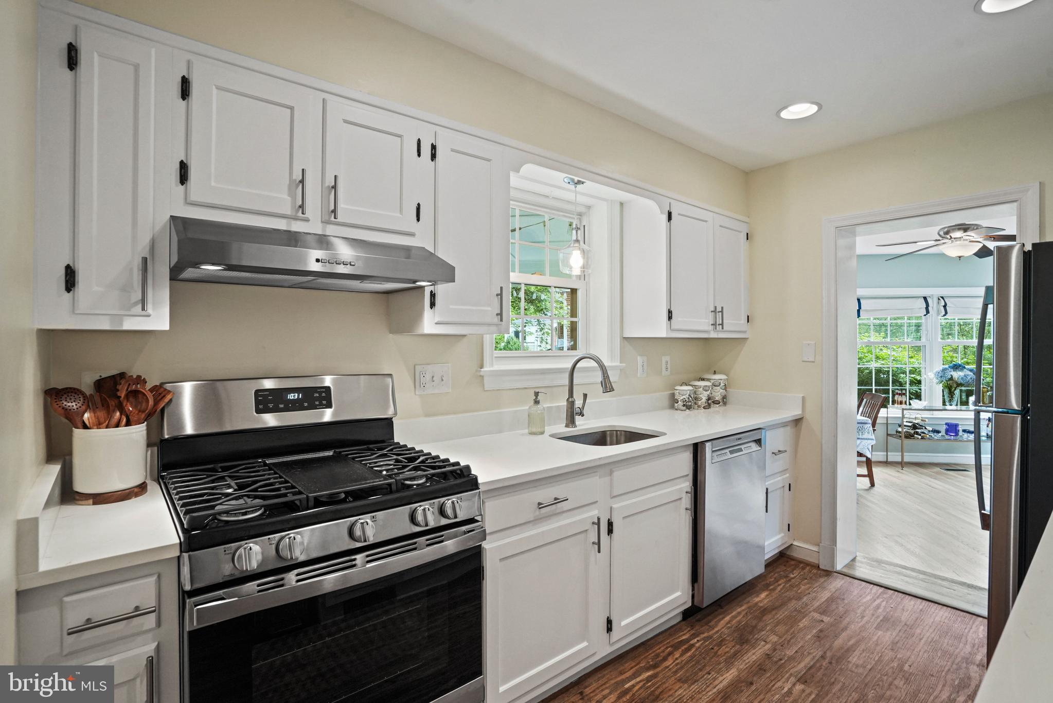 1907 Brisbane Street Silver Spring, MD 20902 - Photo 11 of 39 a kitchen with stainless steel appliances white cabinets and a stove top oven