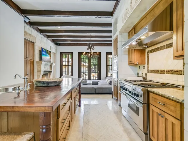 a kitchen with stainless steel appliances granite countertop a stove and a sink
