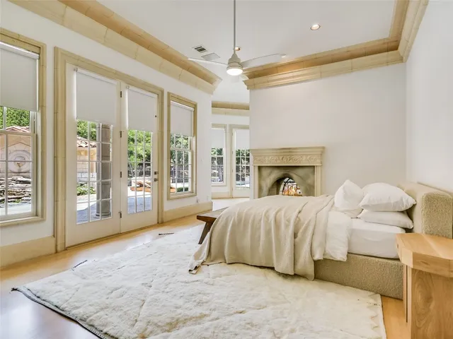 a spacious bedroom with a bed and glass door