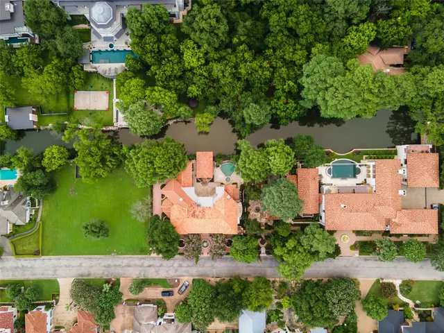an aerial view of a house with a garden and swimming pool