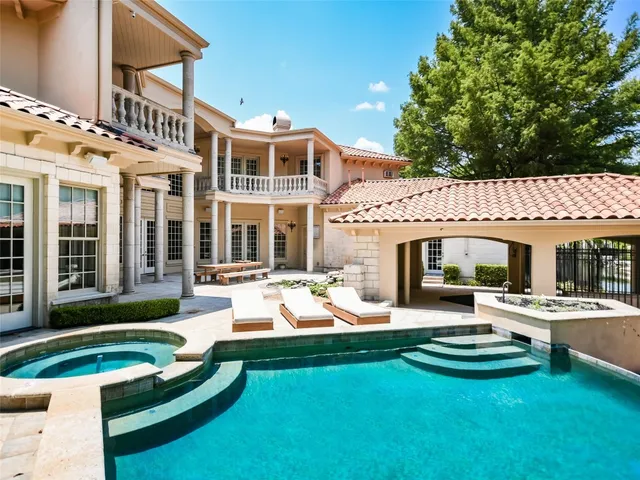 a view of a house with swimming pool and sitting area