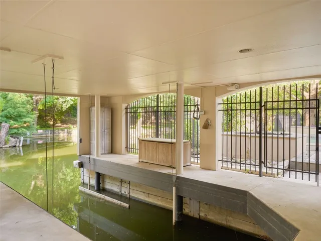 a living room with a large window and pool table