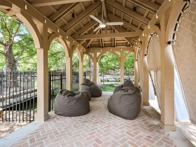 a living room with large windows and furniture