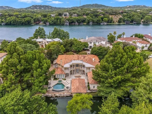 an aerial view of a house with pool lake view and mountain view