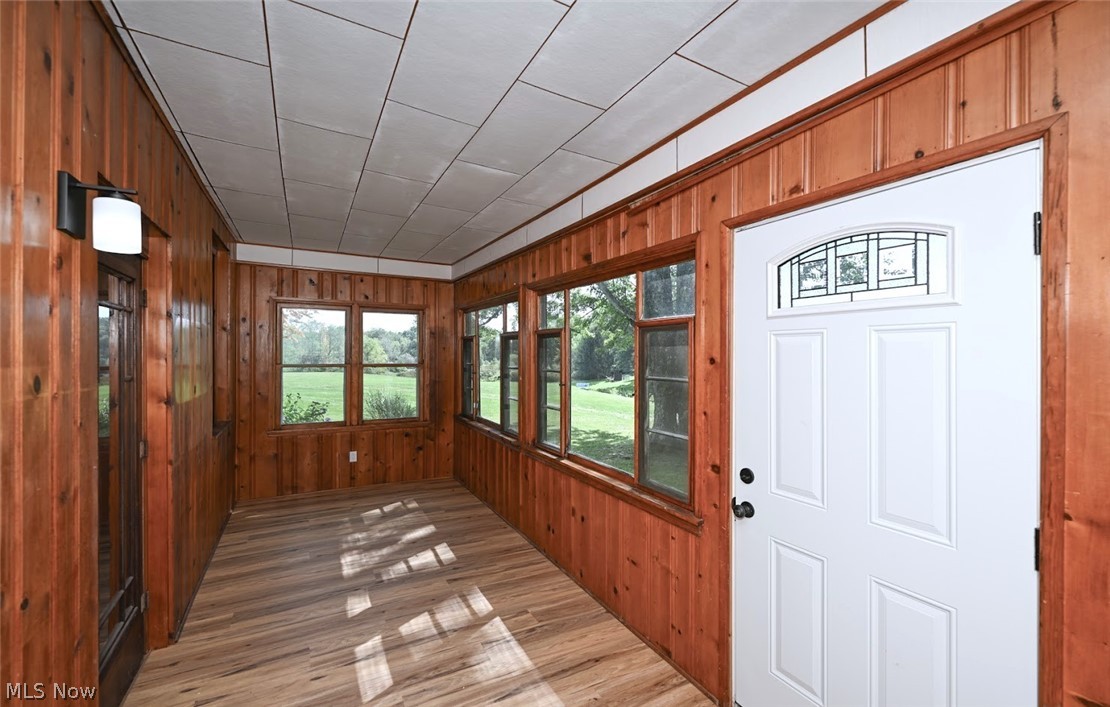 2559 Raber Road Uniontown, OH 44685 - Photo 11 of 41 *FRONT DOOR & HEATED ENCLOSED PORCH PRIOR TO THE MAIN LIVING ROOM ~