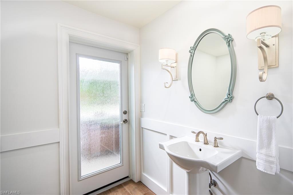 675 Yucca Road Naples, FL 34102 - Photo 15 of 24 a bathroom with a sink and a mirror