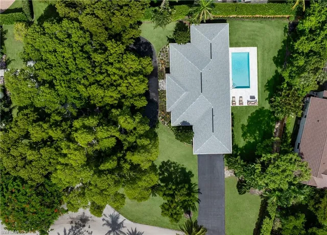 an aerial view of a house with a yard
