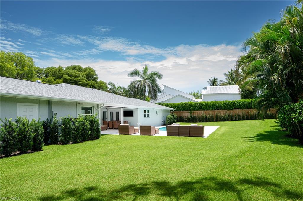 675 Yucca Road Naples, FL 34102 - Photo 21 of 24 a view of house with a yard