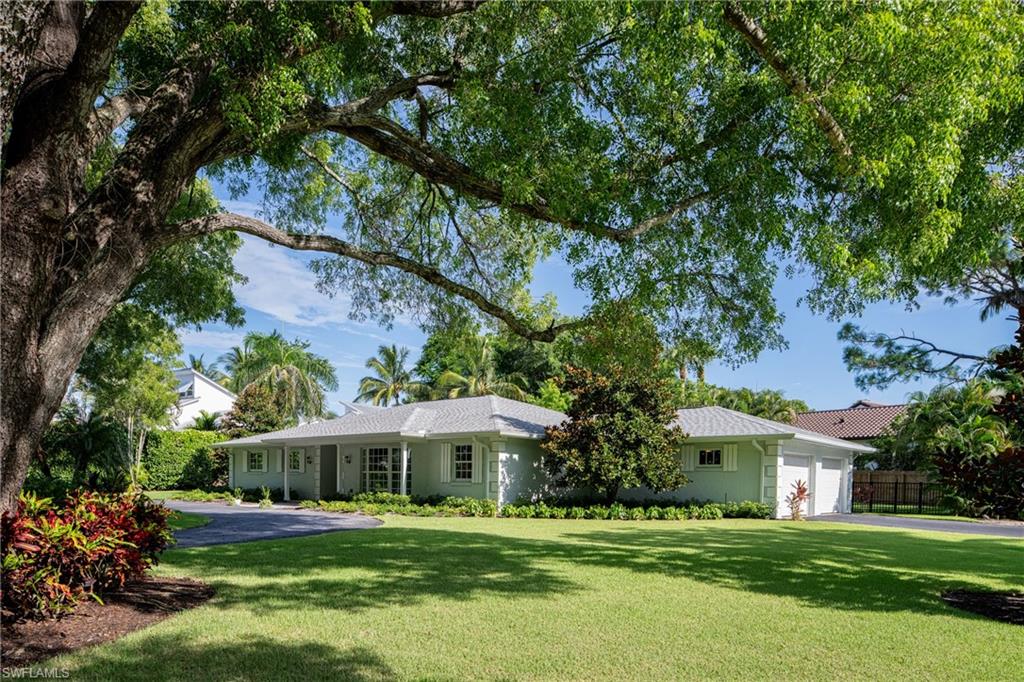 675 Yucca Road Naples, FL 34102 - Photo 23 of 24 a front view of a house with a garden