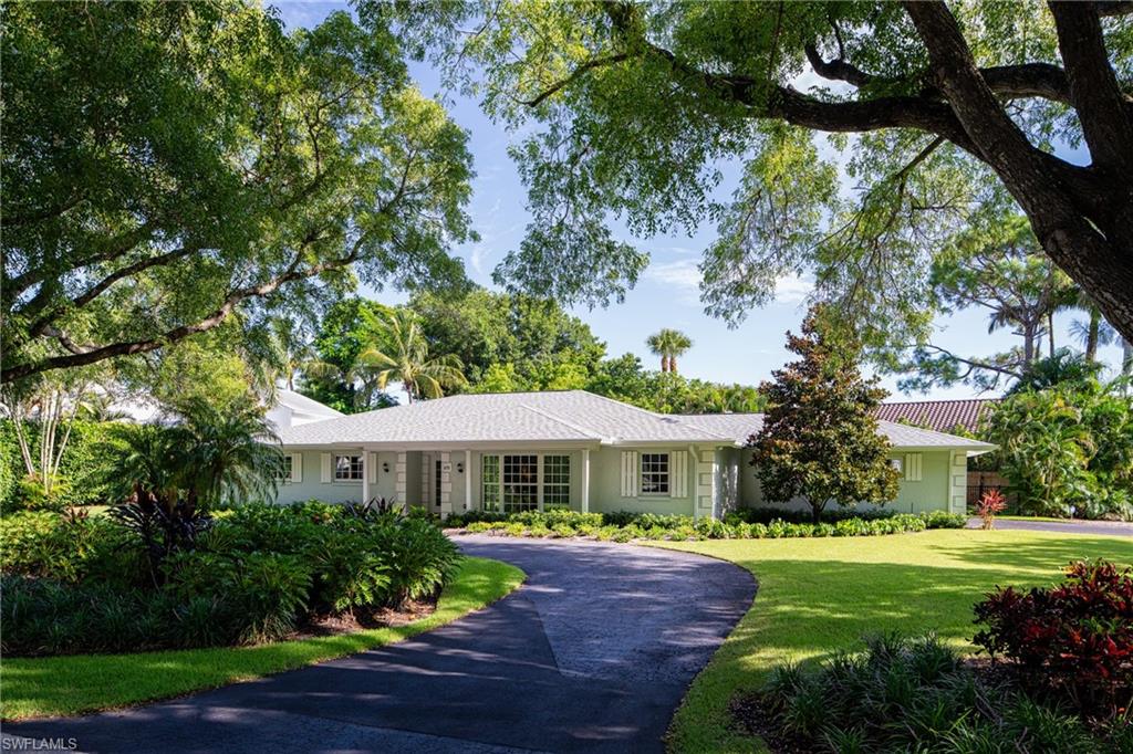 675 Yucca Road Naples, FL 34102 - Photo 24 of 24 a front view of a house with garden and porch