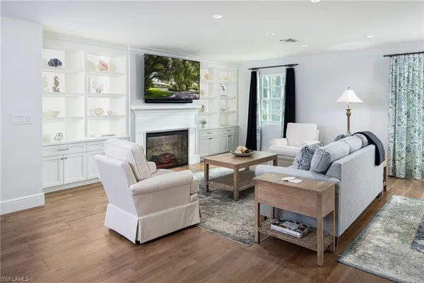 a living room with furniture flat screen tv and a fireplace