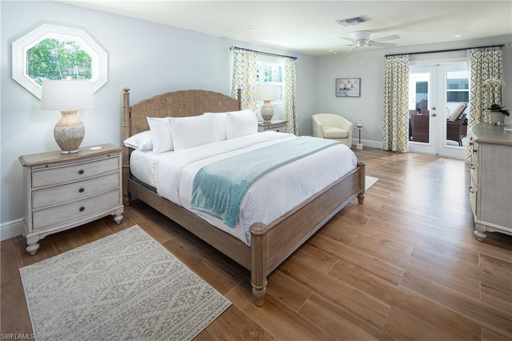 675 Yucca Road Naples, FL 34102 - Photo 8 of 24 a bedroom with bed and window