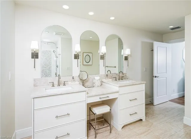 a bathroom with a double vanity sink and a mirror