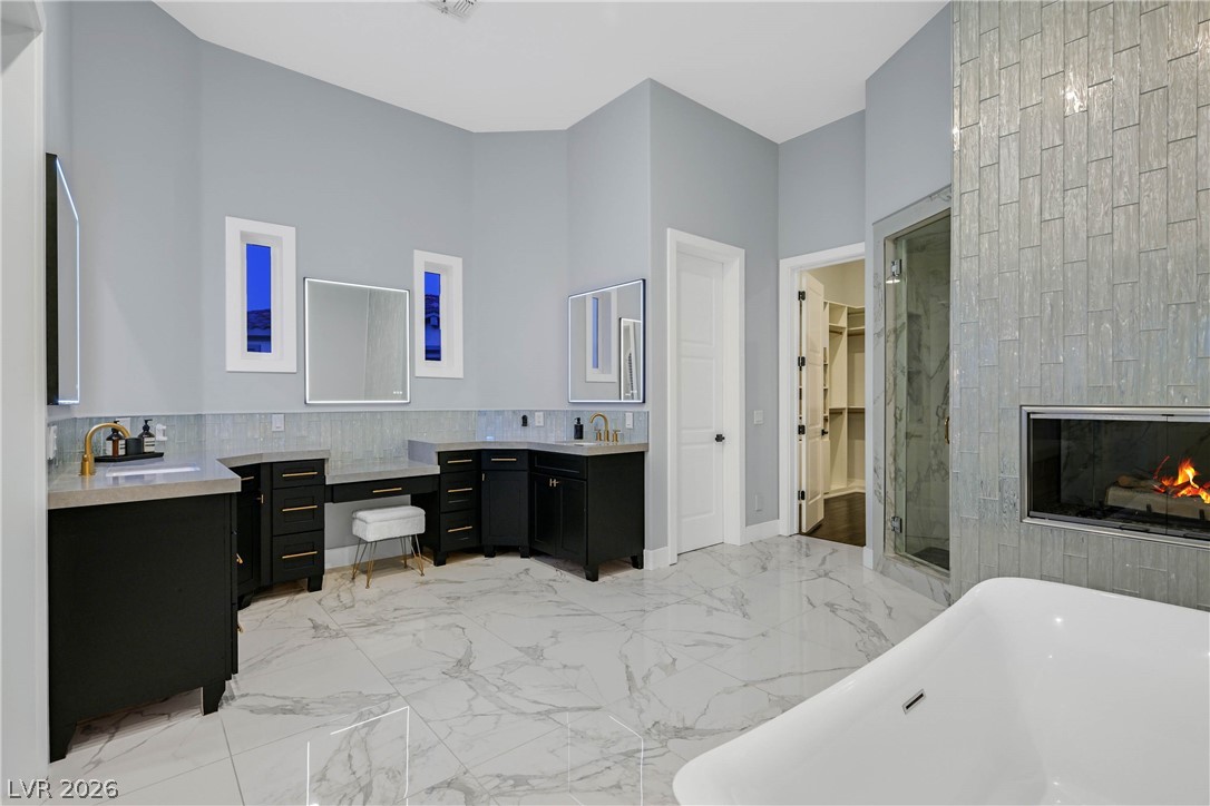 6 Rue Du Ville Henderson, NV 89011 - Photo 59 of 99 Luxurious bathroom retreat featuring elegant finishes and a cozy fireplace.
