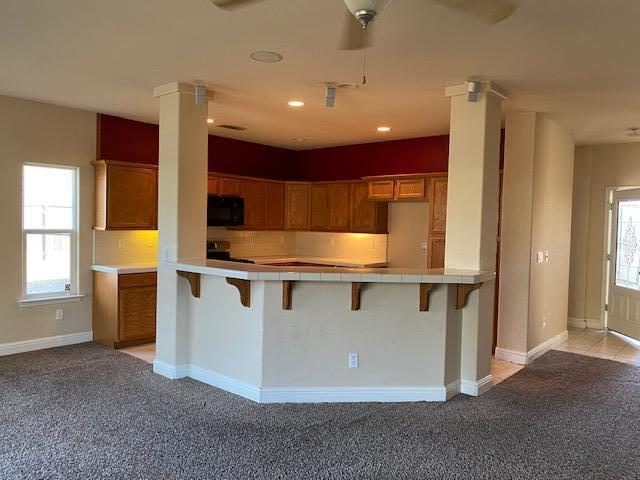 495 Springtime Lane Red Bluff, CA 96080 - Photo 6 of 20 a kitchen with stainless steel appliances granite countertop a stove a sink and a refrigerator with wooden floor