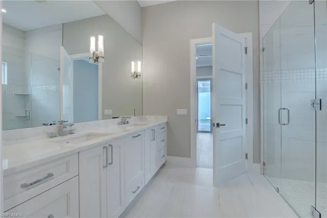 a bathroom with a double vanity sink and mirror